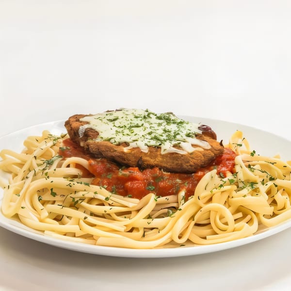Chicken Parmesan with melted cheese and parsley over linguine pasta with red sauce.