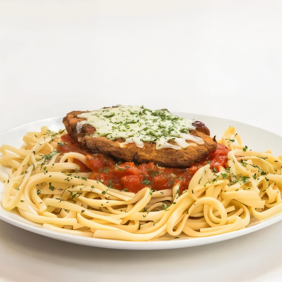 Chicken Parmesan with melted cheese and parsley over linguine pasta with red sauce.